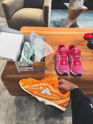 Ronnie Fieg's Kith x New Balance 204L sneaker collaborations in green, orange, and pink.