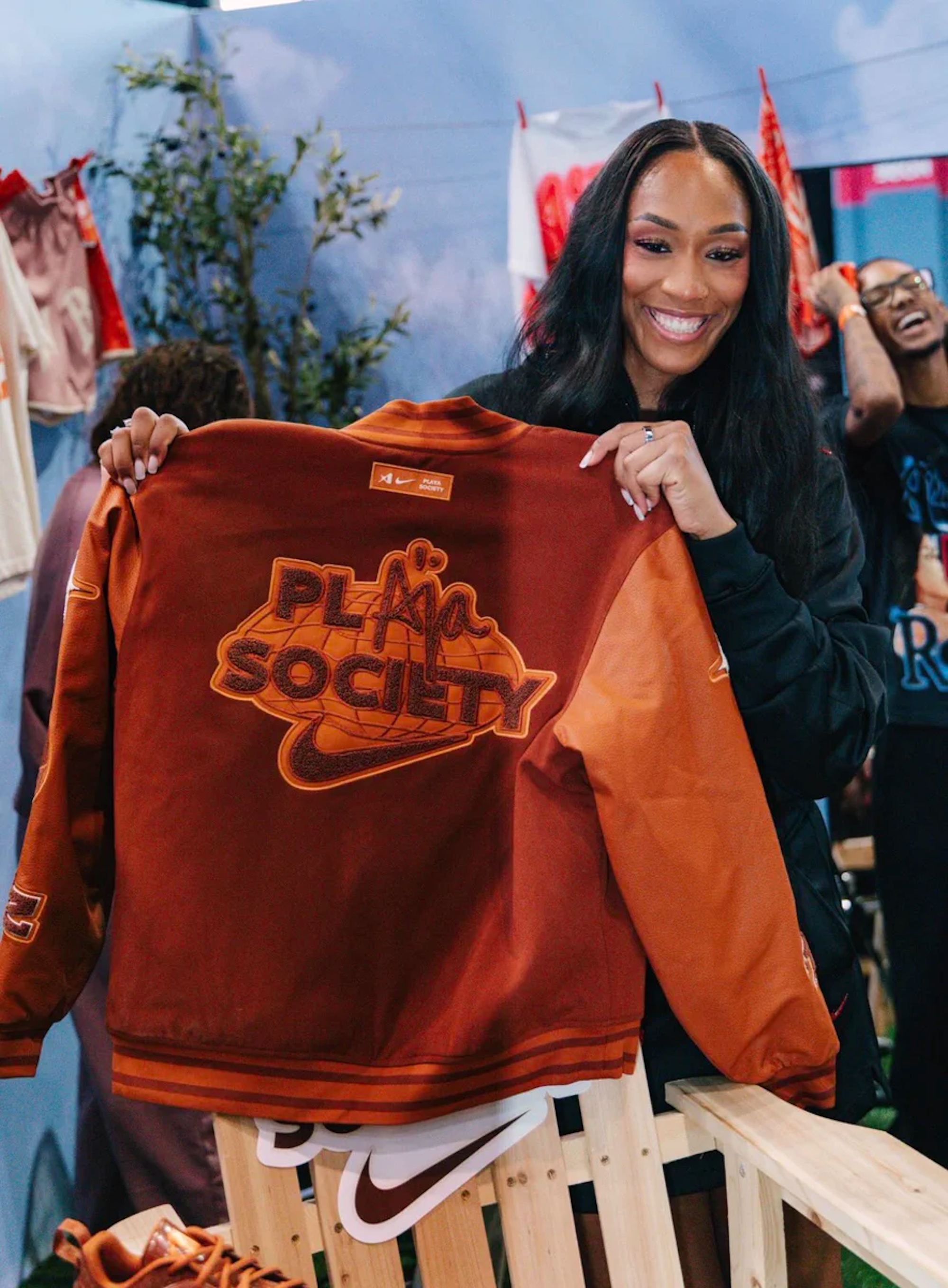 A'ja Wilson holding the Playa Society x Nike Varsity Jacket.