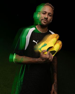 Neymar Jr. holding his PUMA Future 9 by KidSuper. Photo via PUMA.