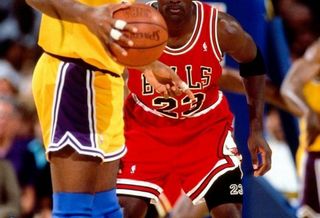 Michael Jordan defending against Magic Johnson in Game 5 of the 1991 NBA Finals against the Los Angeles Lakers.