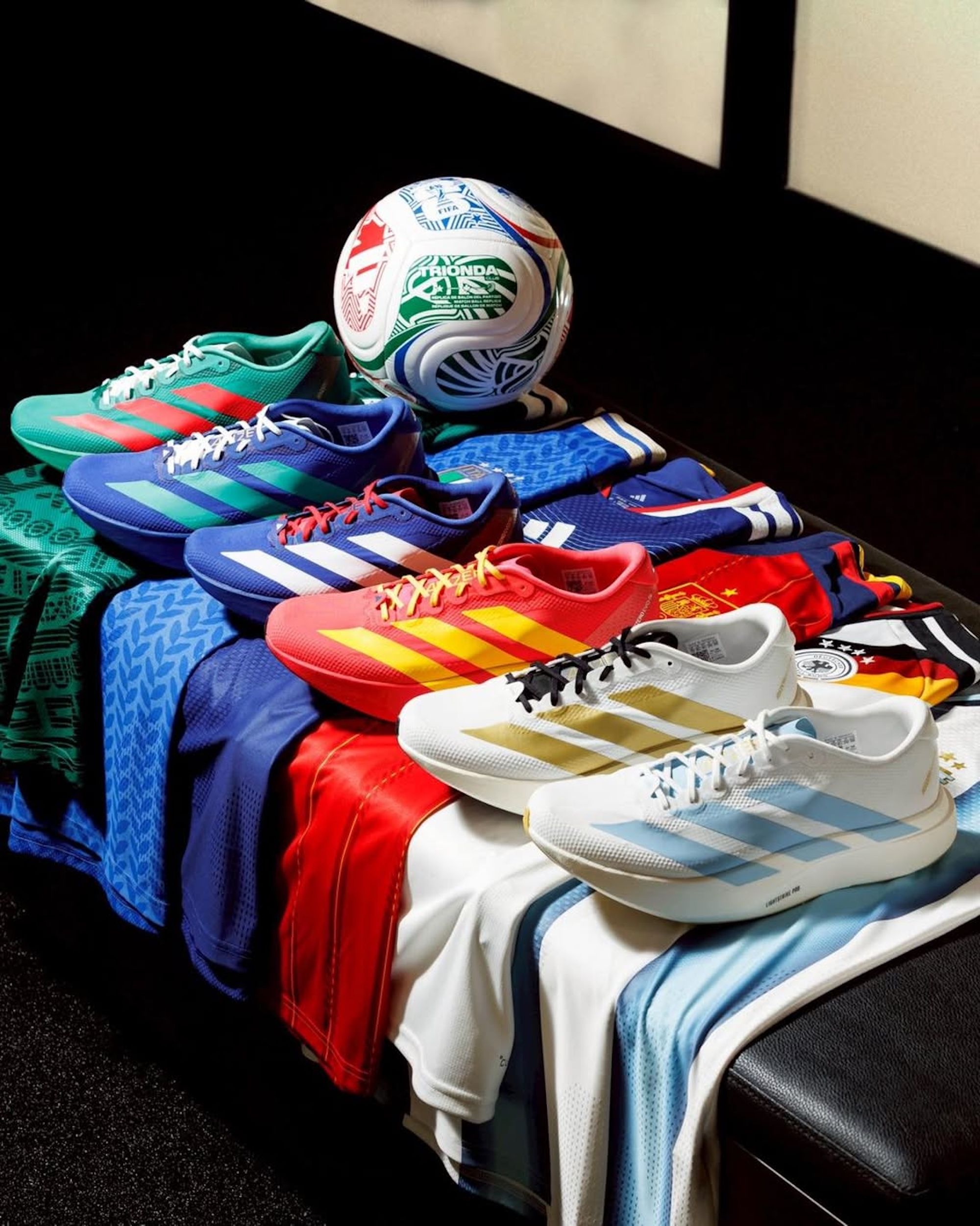 Six pairs of the adidas Adizero Evo SL running shoe seemingly inspired by footballing countries—including Mexico, Argentina, Italy, Japan, Germany, Spain.