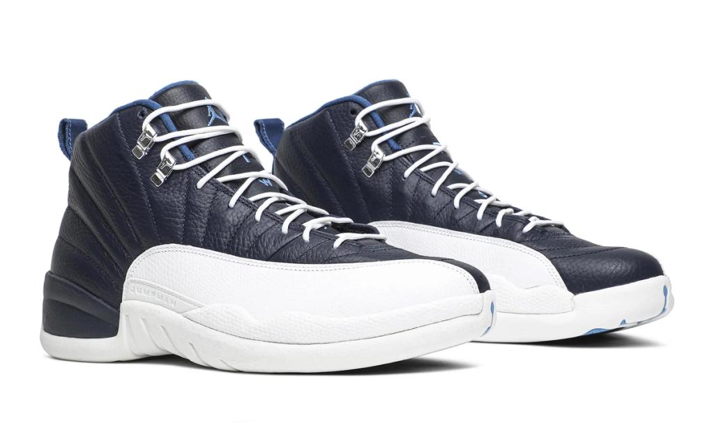Air Jordan 12 in Obsidian colorway, showing the shoe's signature wraparound toe box and structured silhouette in navy blue