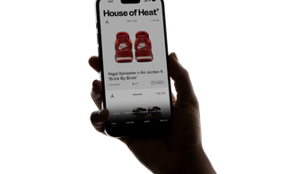 In-hand mock-up of the House of Heat° app running on an iOS device.
