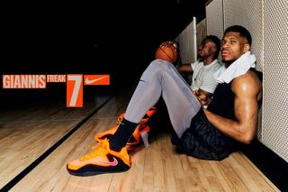 Giannis Antetokounmpo wearing an orange pair of his Nike Freak 7 basketball shoe.