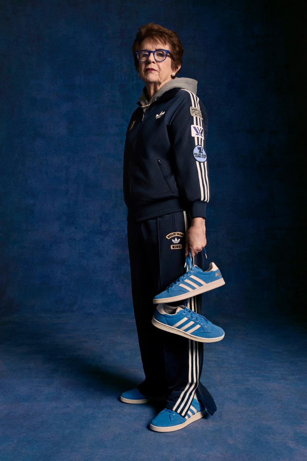 Adidas blue suede shoe reissue honoring Billie Jean King, shown from a three-quarter angle highlighting the suede texture and classic silhouette