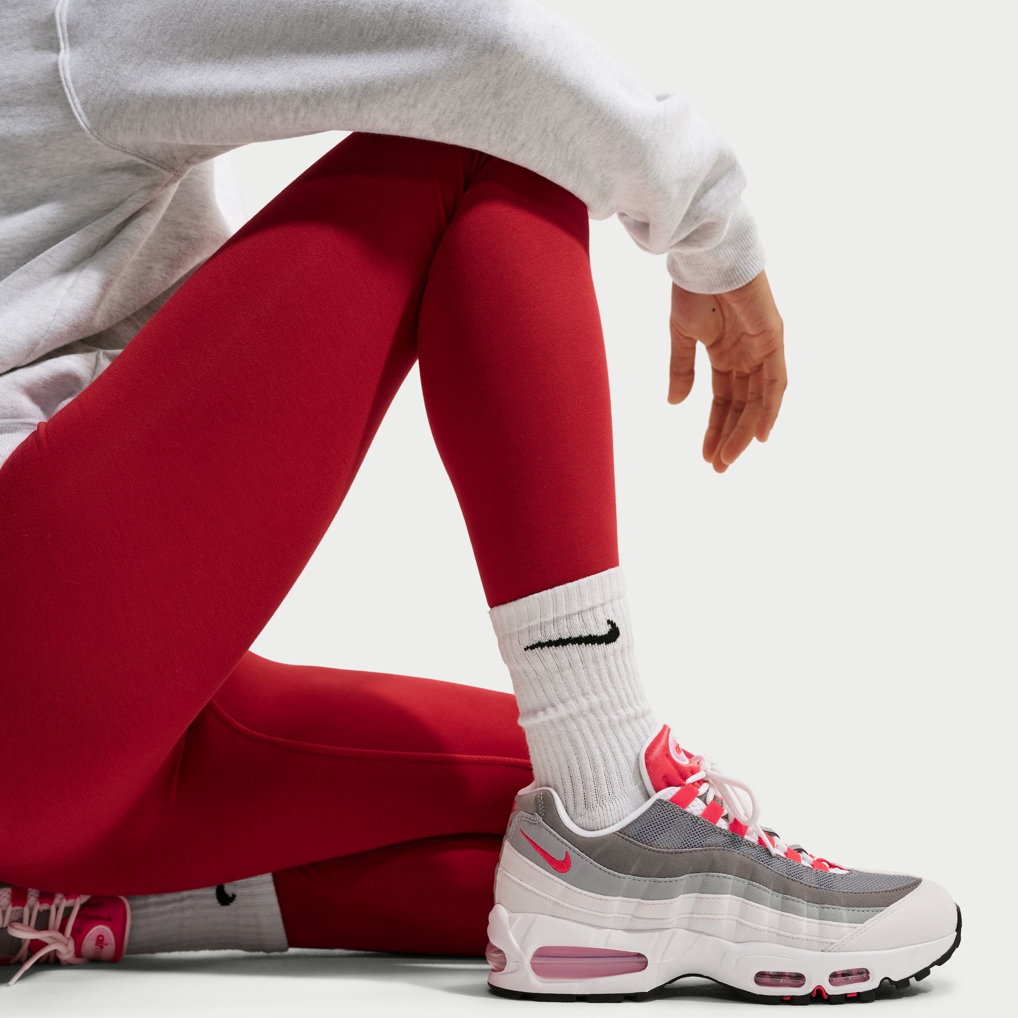 On-foot look at the Women's Nike Air Max 95 "White/Light Crimson" sneaker.