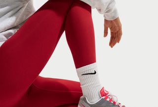 On-foot look at the Women's Nike Air Max 95 "White/Light Crimson" sneaker.