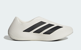 Adidas Purechill recovery slip-on in a "Cloud White/Core Black/Core Black" color scheme.