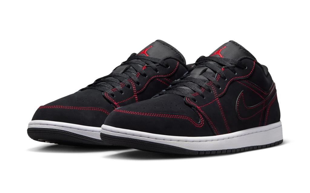 Air Jordan 1 Low in black nubuck with red accent stitching, side profile view