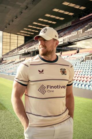 J.J. Watt wearing Burnley's 26/27 Away Jersey.