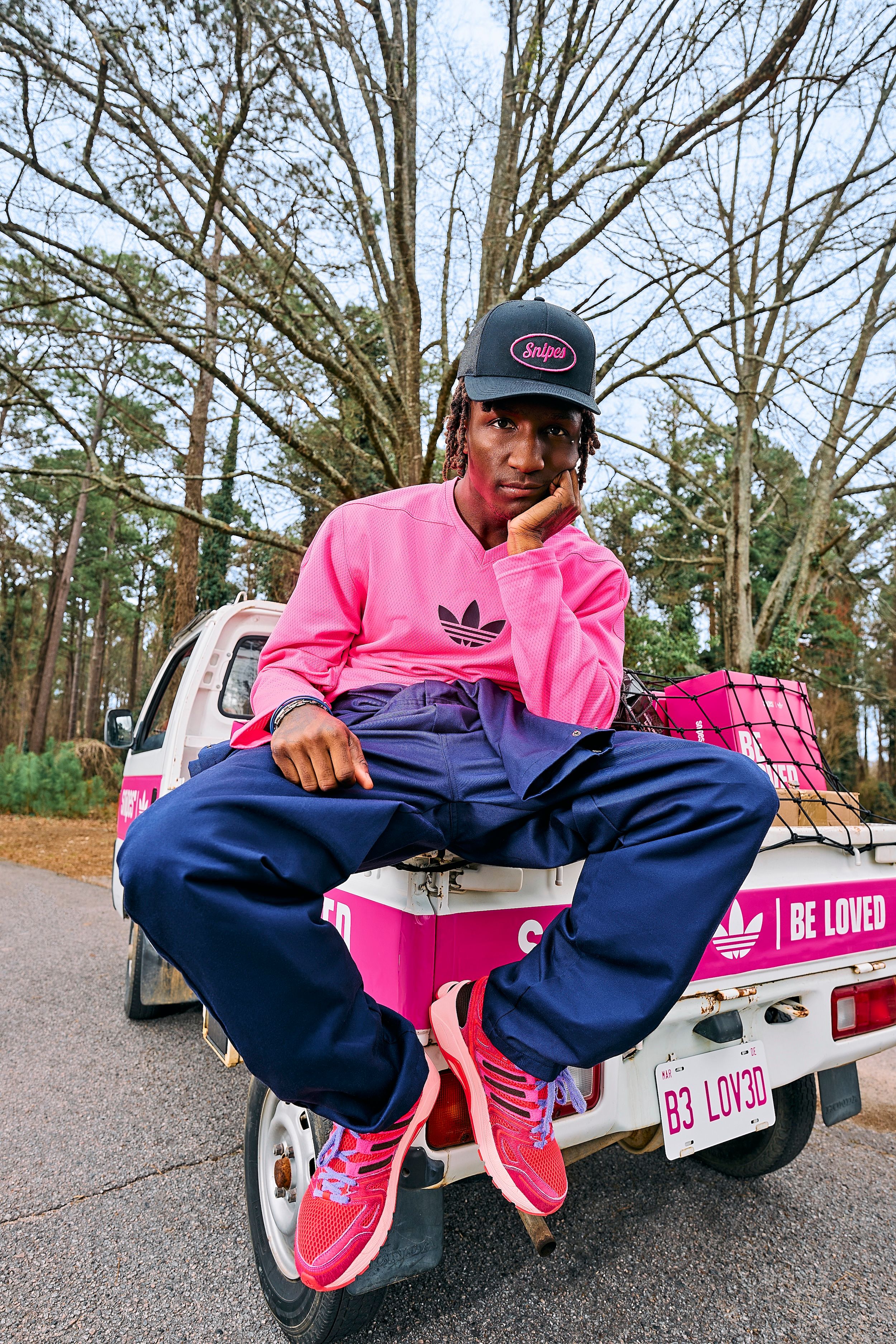 Twitch partner Raud wearing SNIPES' pink-covered "Be Loved" adidas AdiStar Control 5 collaboration.