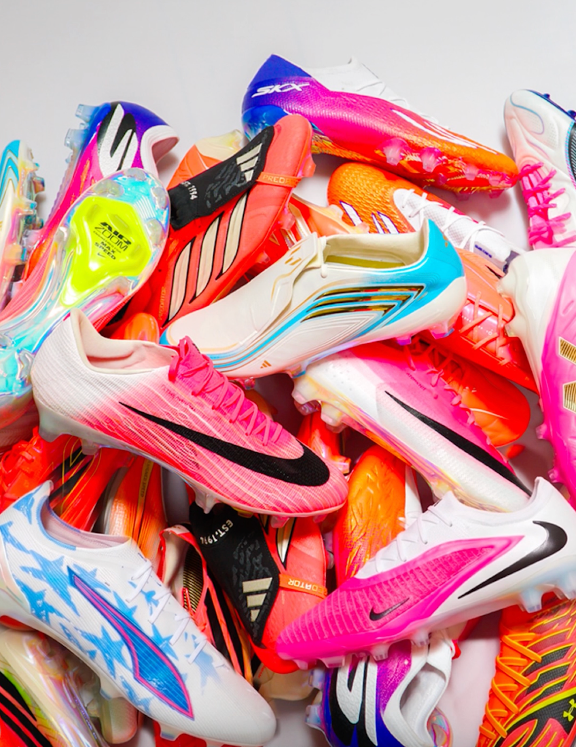 Group photo of over a dozen 2026 World Cup™ boots from adidas ("Road to Glory"), Nike ("Breakout"), PUMA ("Showtime") & others. Photo by BOOTSCULTURE®.