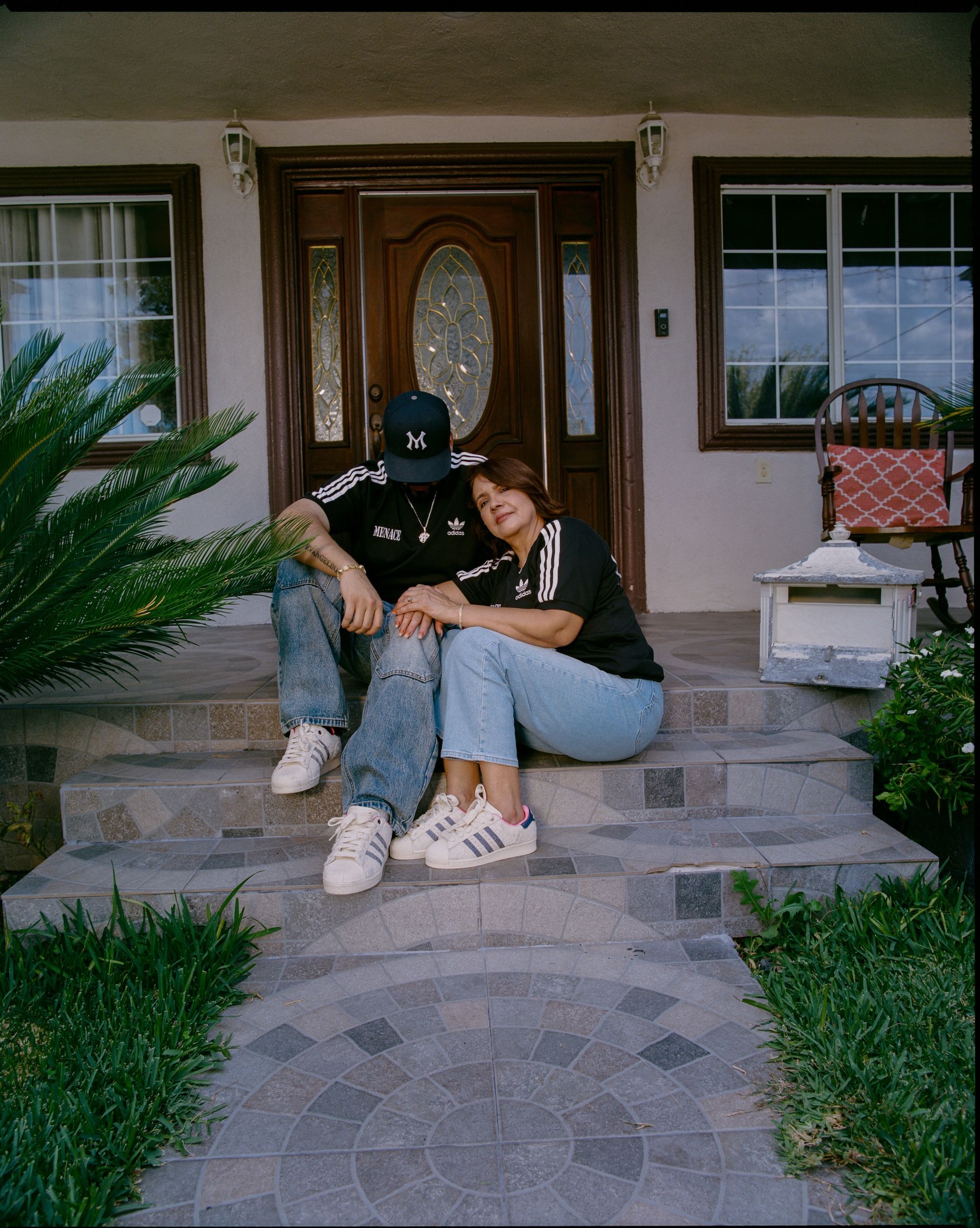 Steven Mena & his mother, Evangelina, wearing the "Heirlooms" adidas Superstar by MENACE (Fall 2025). Photo via adidas Originals.