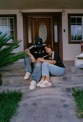 Steven Mena & his mother, Evangelina, wearing the "Heirlooms" adidas Superstar by MENACE (Fall 2025). Photo via adidas Originals.