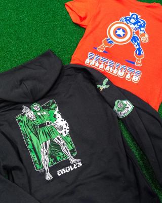 Champion Hoodie & T-Shirt of Doctor Doom for the Philadelphia Eagles & Captain America for the New England Patriots, respectively. Photo via Disney Style.
