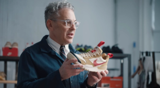 Tom Sachs holding a pair of his NikeCraft Mars Yard 3.0 sneaker collaboration.