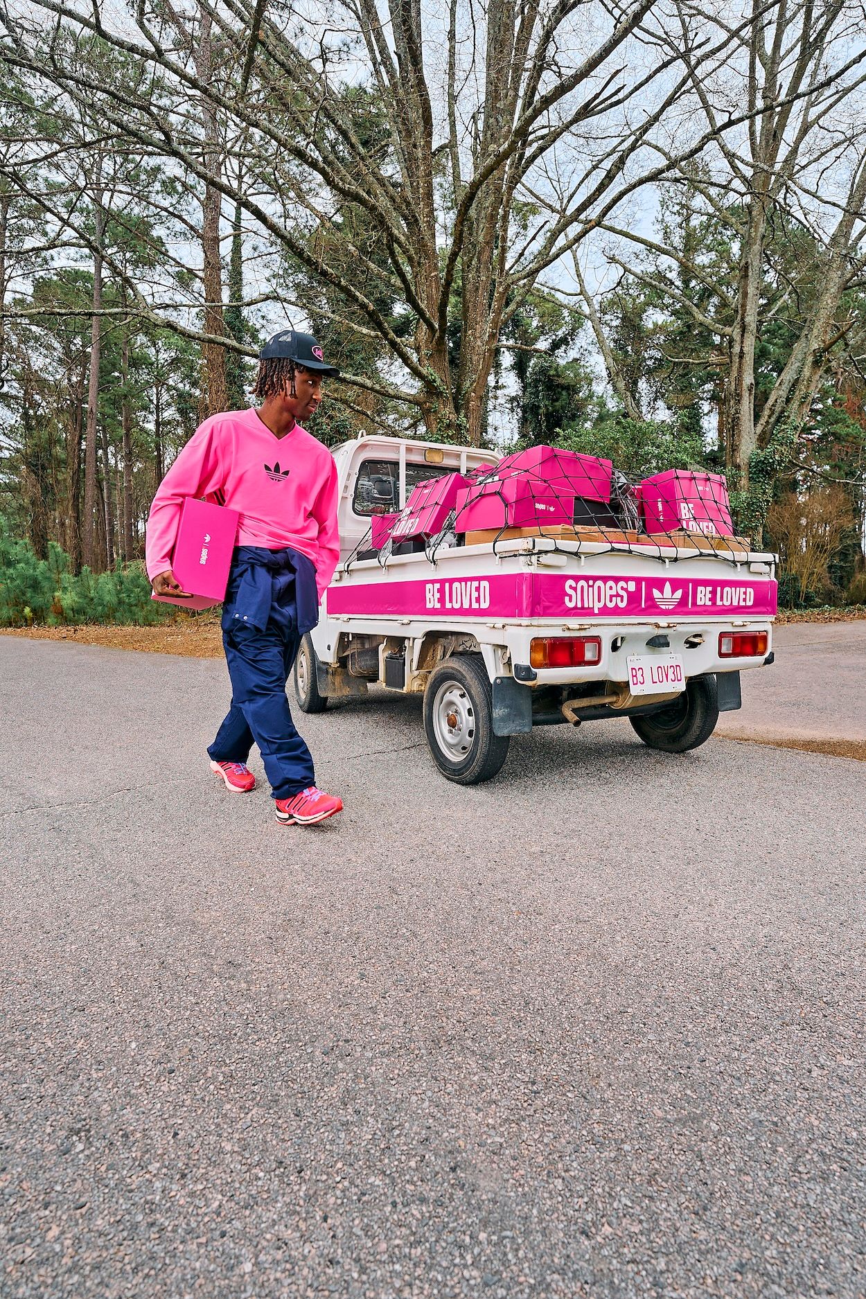 Raud in "Loved Delivered" Campaign, wearing SNIPES' pink-covered adidas AdiStar Control 5 "Be Loved" collaboration.