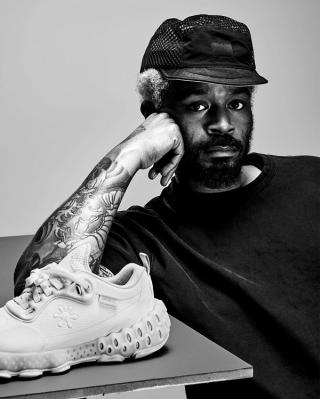 Salehe Bembury posing next to a debut style of his SPUNGE Osmosis sneaker design.