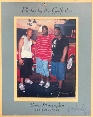 Printed photo from a go-go event at the Eastside Club (1992). Attendees wearing grey, reflective New Balance sneakers. Photo via Nayion Perkins/DCist.