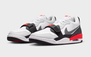 Jordan Legacy 312 Low in a "White/Infrared 23/Black/Cool Grey" color scheme.