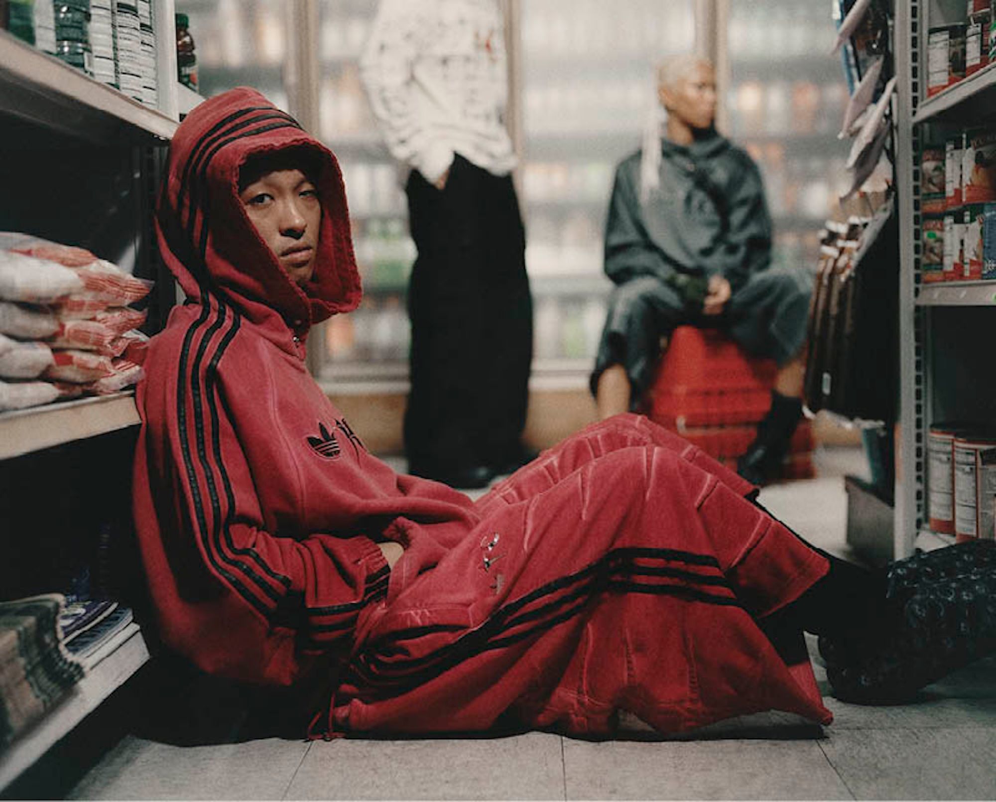 Campaign photo for Thug Club's Spring 2026 collection with adidas Originals, featuring sweatsuits and footwear.