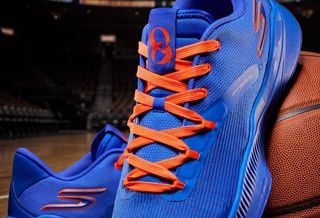 New York Knicks player OG Anunoby's "NYC Blue" Skechers Basketball SKX_Nexus shoe in a blue-and-orange color scheme, available for pre-order.