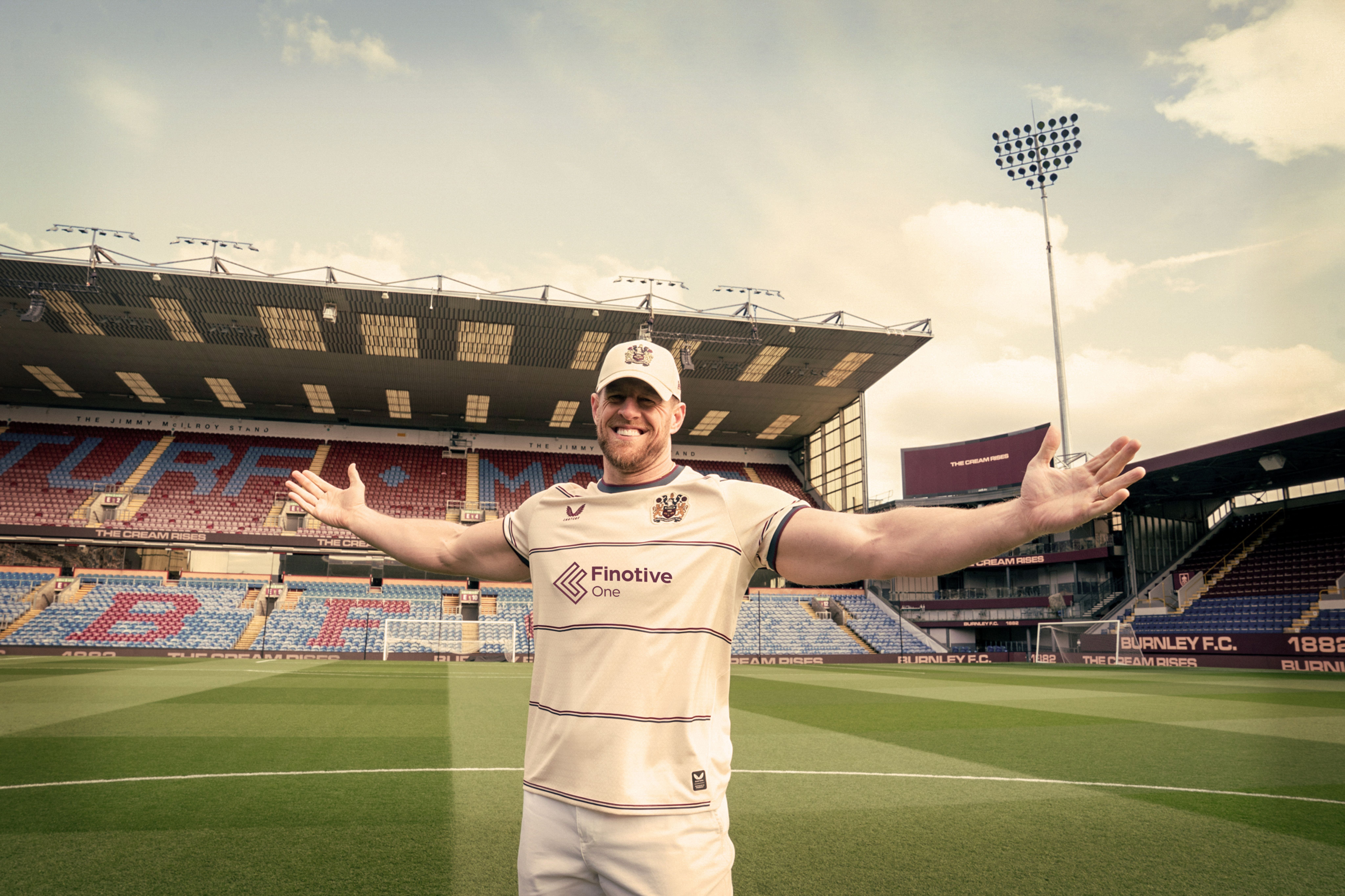 J.J. Watt wearing Burnley's 26/27 Away Jersey inside Turf Moor.