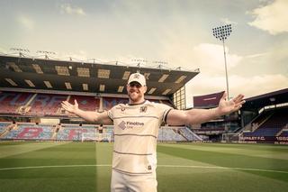 J.J. Watt wearing Burnley's 26/27 Away Jersey inside Turf Moor.