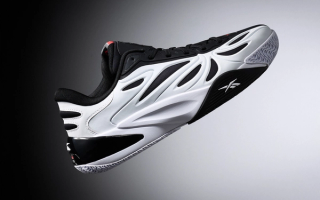 Angel Reese Modeling the Reebok Angel Reese 1 "Receipts Ready" basketball shoe.