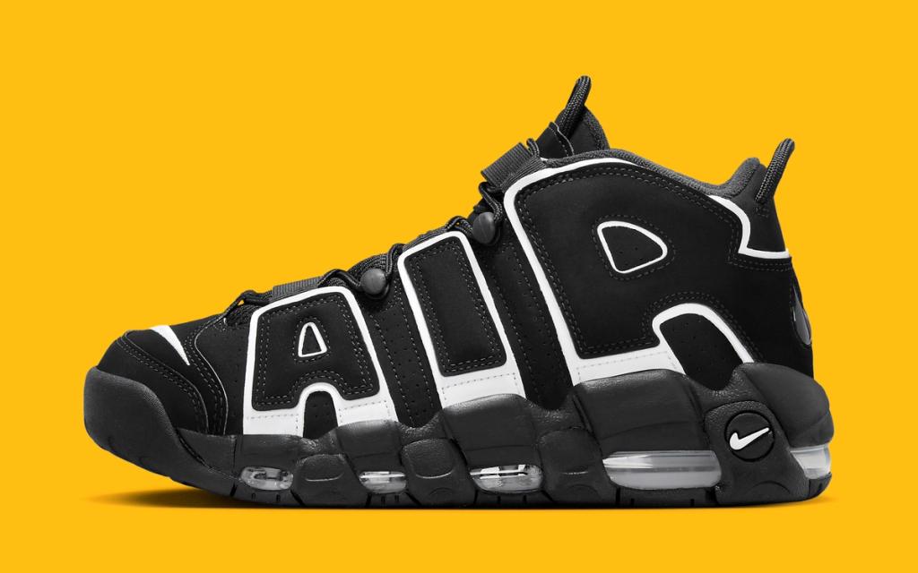 Nike Air More Uptempo in White and Black colorway, front three-quarter view showing oversized swoosh and ankle collar