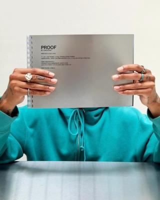 Cam Hicks holding "PROOF" Publication. Photo via Cam Hicks.