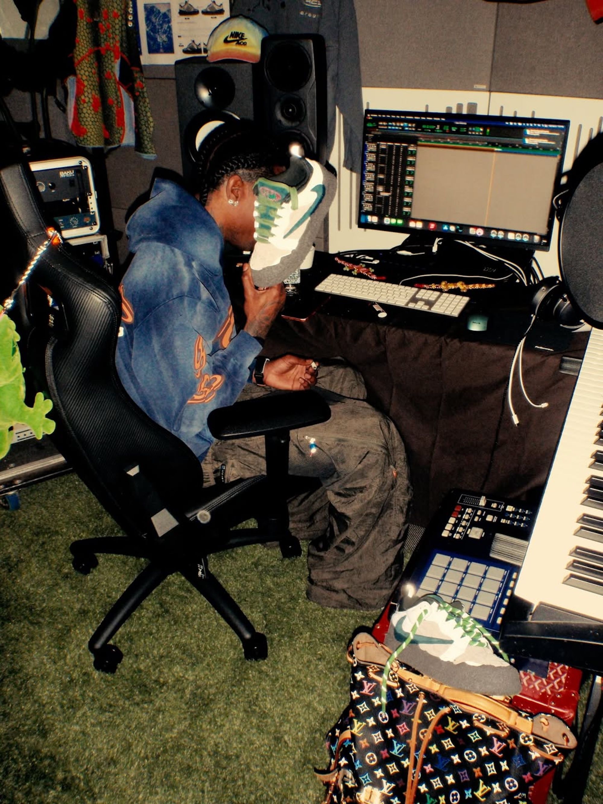 Travis Scott holding an unreleased collaboration with Cactus Plant Flea Market on the Nike Air Flea 1.