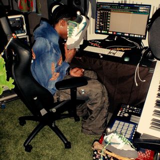 Travis Scott holding an unreleased collaboration with Cactus Plant Flea Market on the Nike Air Flea 1.