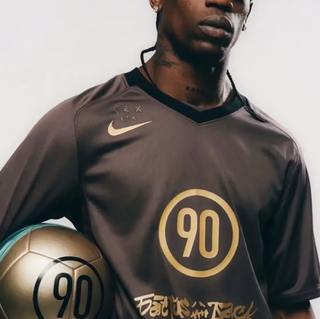Travis Scott wearing a Cactus Jack-branded Nike Total 90 football jersey.
