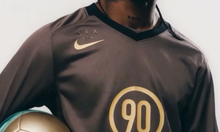 Travis Scott wearing a Cactus Jack-branded Nike Total 90 football jersey.