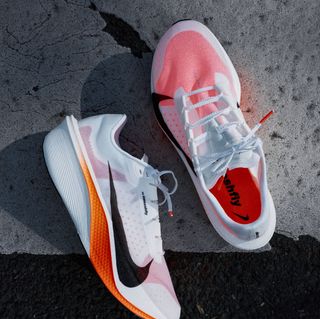 All-new Nike Swooshfly marathon racer, informed by athlete insight from China, in a white-and-orange "Proto" color scheme.