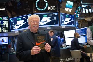 Phil Knight holding a copy of his Shoe Dog memoir (April 2016). Photo via New York Stock Exchange on Facebook.