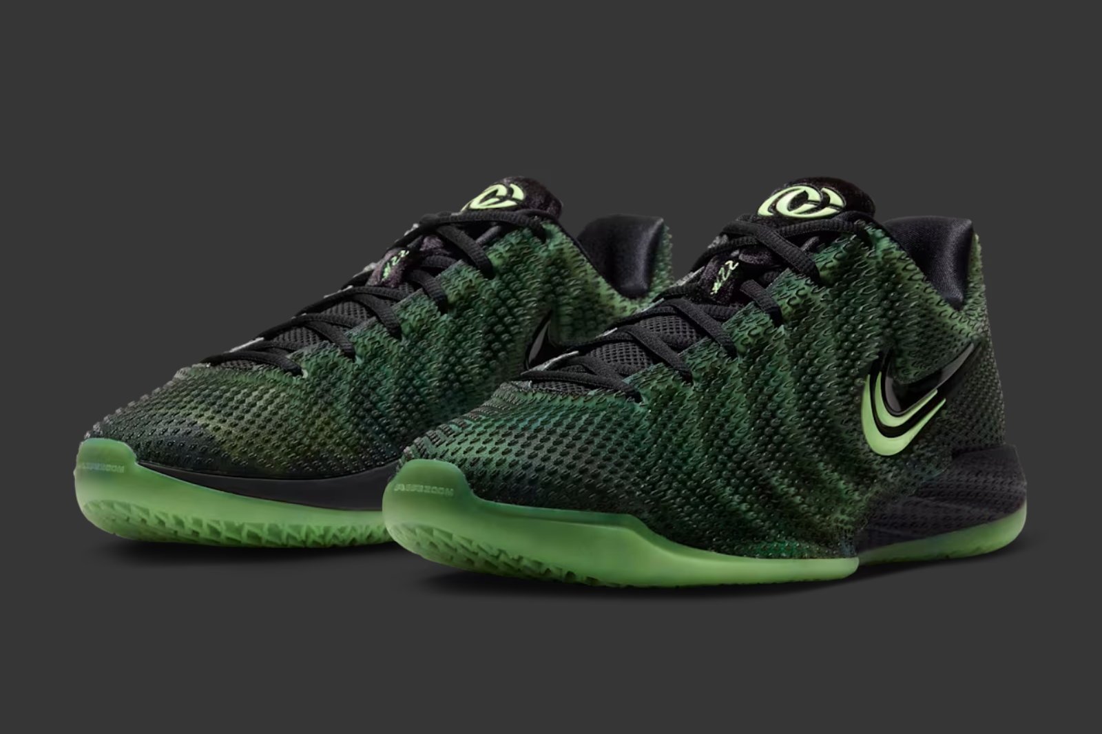 Caitlin Clark showing off Nike Caitlin 1 "Halloween" basketball shoe in a "Black/Ghost Green/Mint Foam/Racer Blue" color scheme.