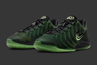 Caitlin Clark showing off Nike Caitlin 1 "Halloween" basketball shoe in a "Black/Ghost Green/Mint Foam/Racer Blue" color scheme.