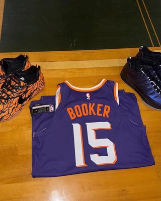 Devin Booker Phoenix Suns Jersey with the "Eggplant" Nike Book 2 in the background. Photo via Devin Booker.