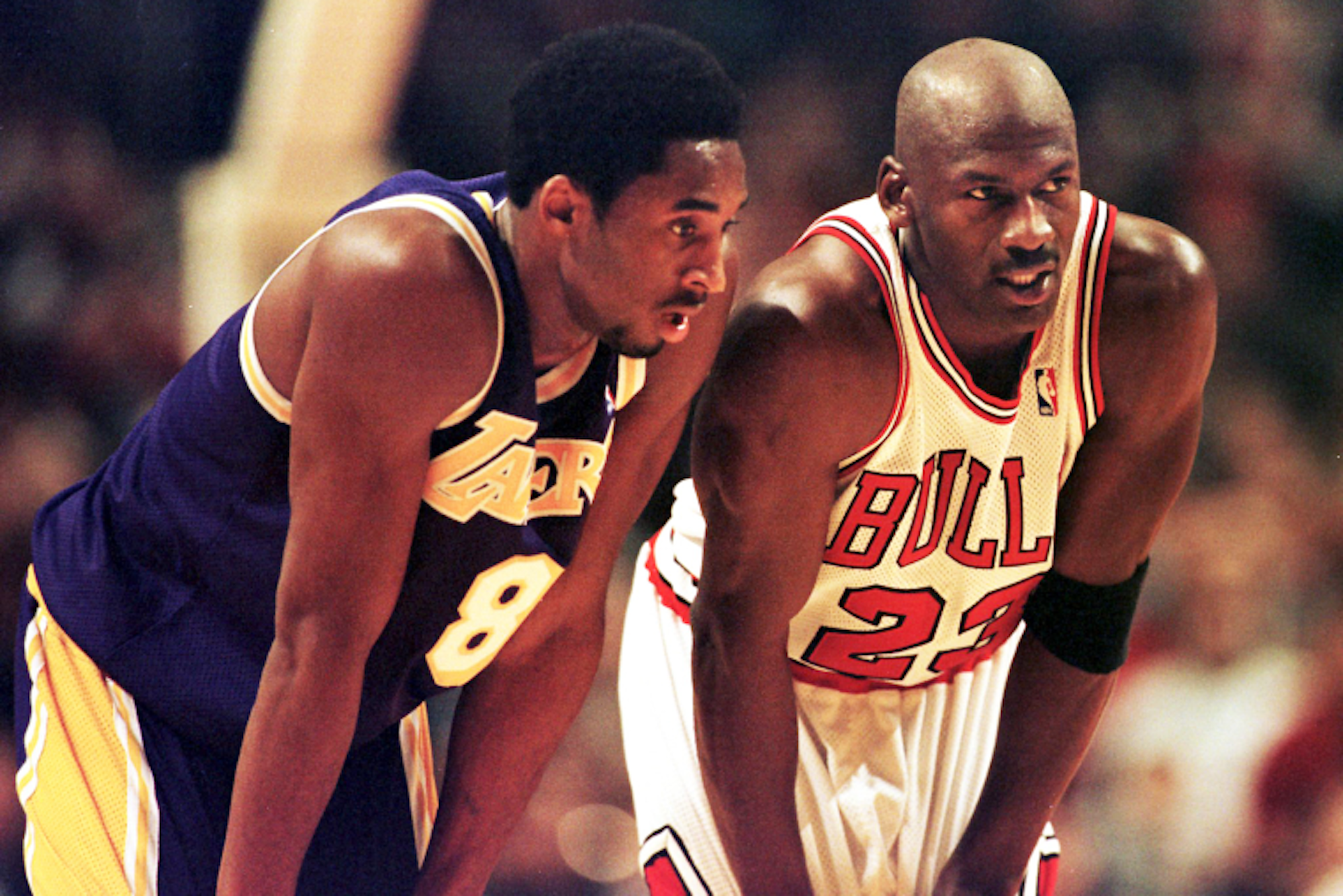 Kobe Bryant, Michael Jordan talking (Dec. 17, 1997). Photo by Vincent Laforet /AFP via Getty Images.