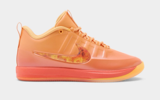 Nike Book 2 "Phoenix" basketball shoe in a "Sundial/Noir/Safety Orange/Medium Ash" color scheme.