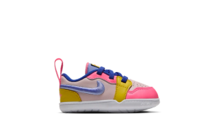 Toddler's Space Jam x Jordan First 1 sneaker in a "Light Soft Pink/Sunset Pulse/Varsity Royal/Aluminium" color scheme, celebrating the 30th anniversary of Space Jam.
