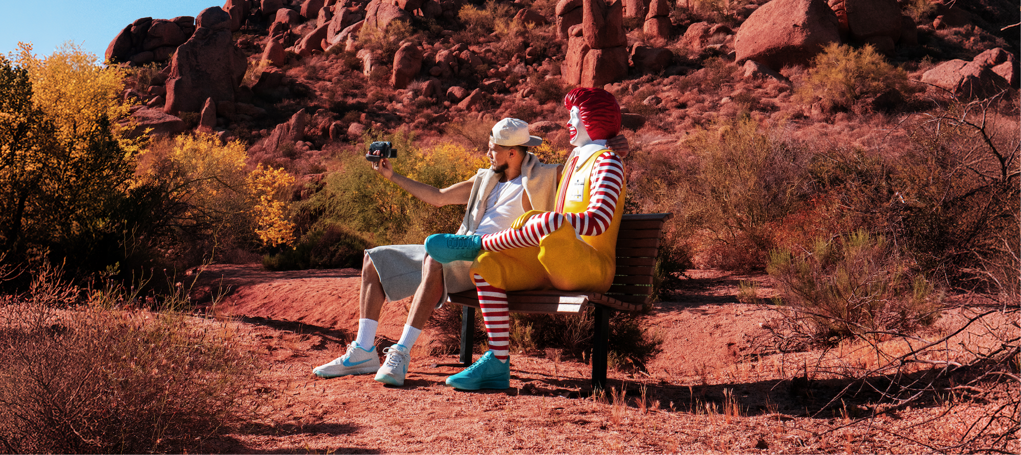 Devin Booker with Ronald McDonald while wearing special-edition Nike Book 2 shoes. Photo via McDonald's.