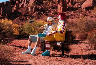 Devin Booker with Ronald McDonald while wearing special-edition Nike Book 2 shoes. Photo via McDonald's.