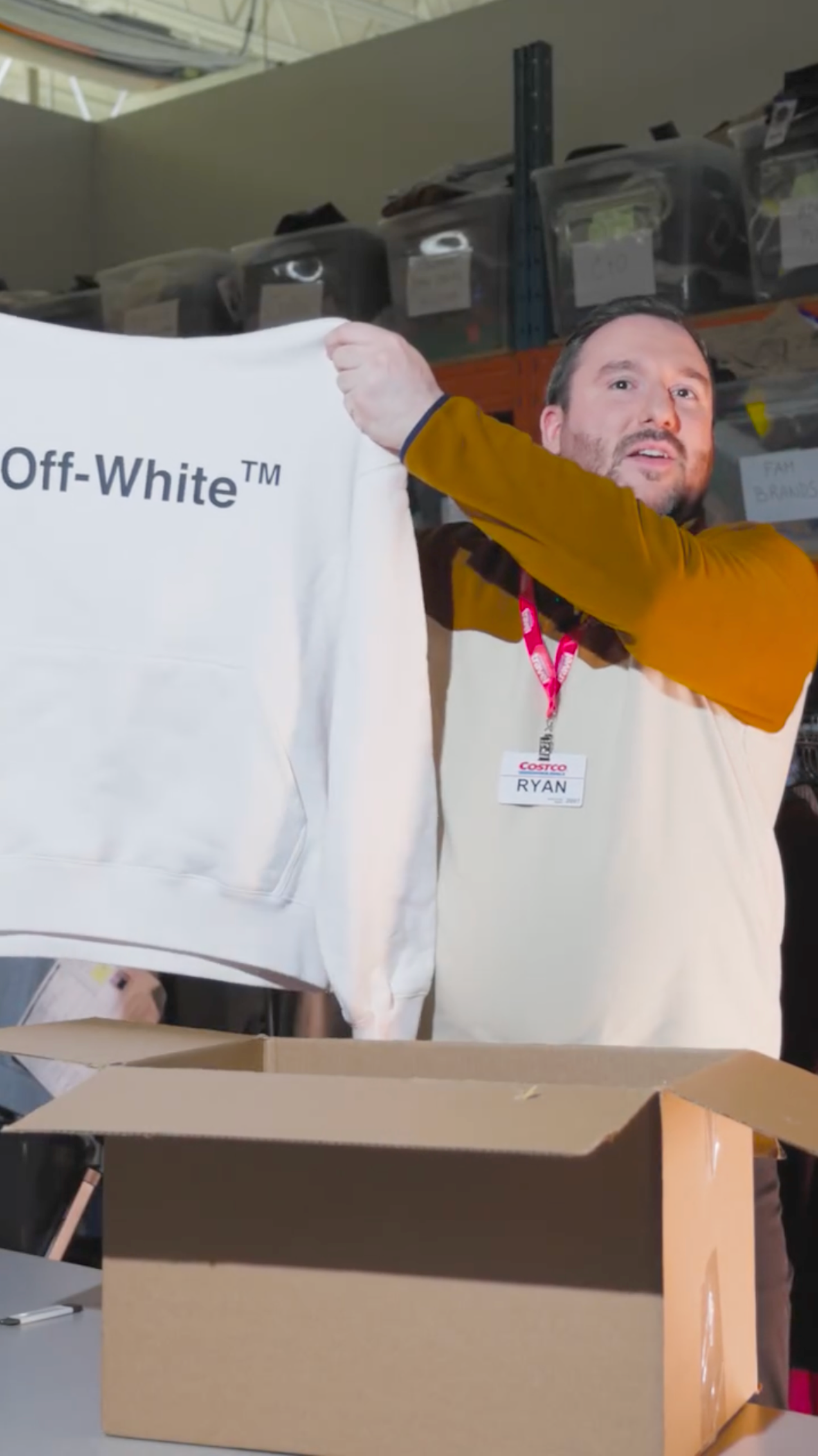 Ryan Bastien, Men's Apparel Buyer at Costco Canada, holding Off-White™ Hooded sweater.