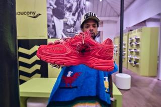 Westside Gunn holding his red Saucony Grid Jazz 9 sneaker collaboration.