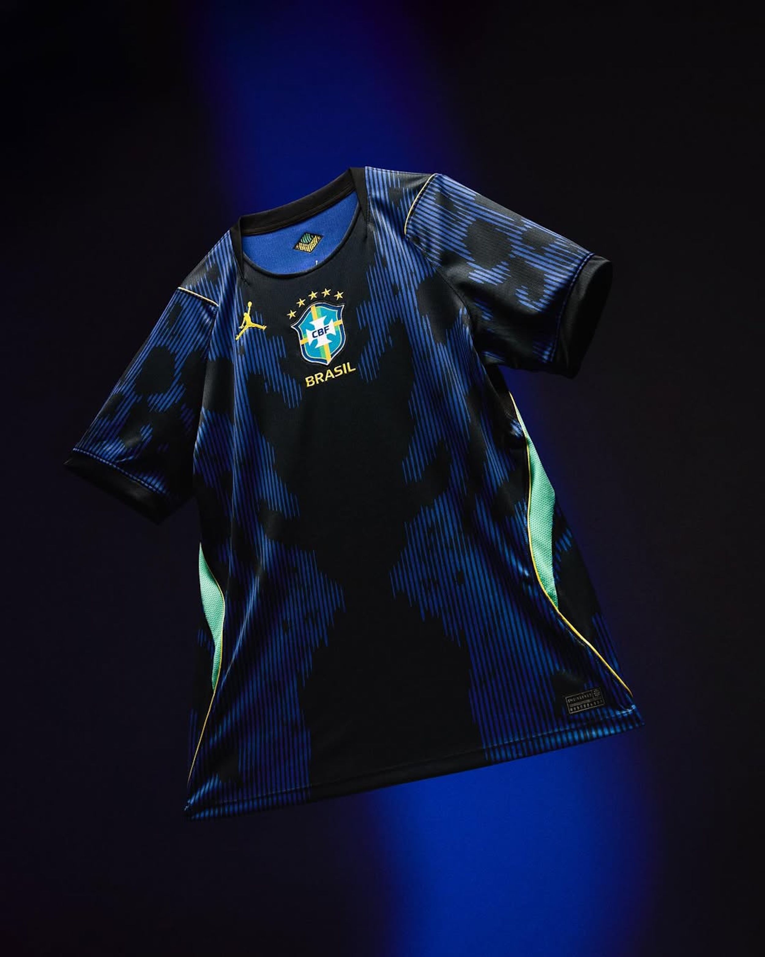 Floating Brazil 2026 World Cup™ Away kit by Jordan Brand, featuring a black-and-blue abstract pattern inspired by the poison dart frog—complete with yellow Jumpman logo on the right chest.
