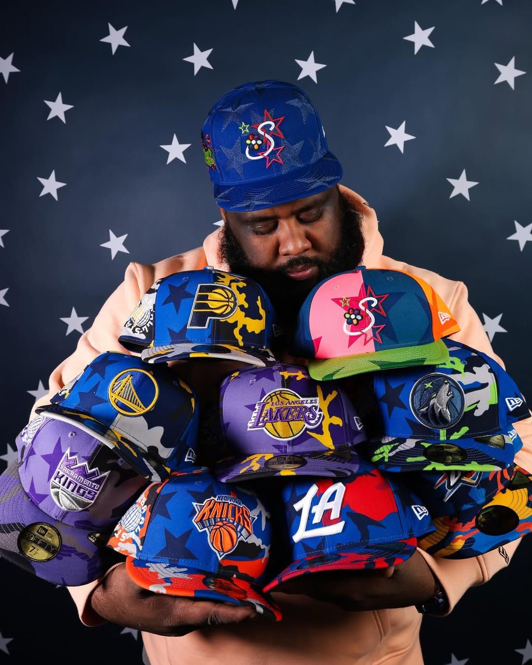 Jae Tips holding multiple New Era cap collaborations for NBA All-Star Weekend 2026.