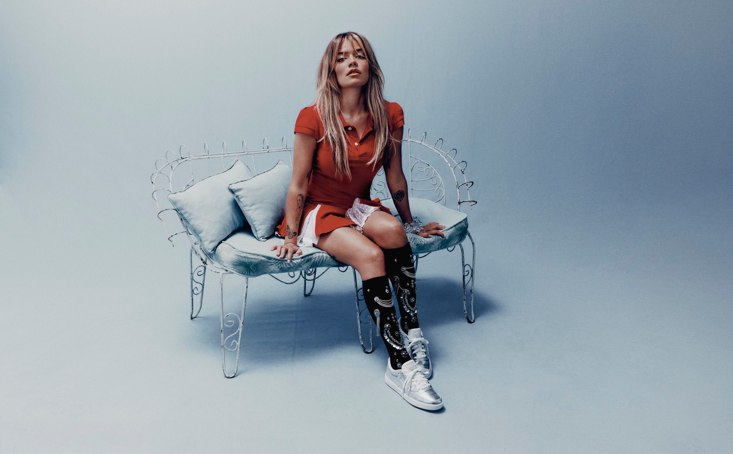 Karol G Wearing Silver Reebok Club C 85 Sneaker for Women.
